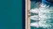 © Bogdan - Aerial view of a hydroelectric dam with water discharge into a turquoise river.