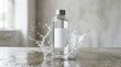© Zaidi - Clear water bottle with splash in studio setting