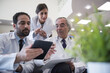 © .shock - Middle Eastern eye hospital doctors reviewing patient data on tablet during team meeting at Egyptian clinic