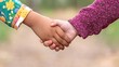 © Arsira - Two young children holding hands outdoors wearing colorful patterned clothing sleeves