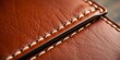 © alain louis - Close-up of handcrafted leather wallet, stitching detail visible, dark brown, leather