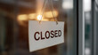 © photo for everything - A stark white 'CLOSED' sign pendant, clearly visible, hangs on a glass door, signifying temporary business closure, end of service, or unavailability
