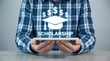 © Mudassir - Man holding a digital tablet displaying a glowing graduation cap icon with dollar signs representing financial assistance for university students