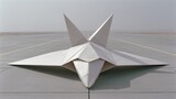 Large paper airplane shaped like a modern fighter jet on a runway.