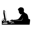 © Zembro - Silhouette of a person working on a desktop computer at a desk