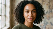 © hadid - Authentic and captivating portrait of a young woman with natural curly hair and a confident gaze, showcasing unique beauty and a thoughtful demeanor