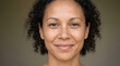 © hadid - Candid and genuine headshot of a beautiful African American woman with curly hair and a warm, inviting smile, radiating confidence and approachability