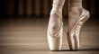 © Demas - Close-up of a ballerina's feet in pointe shoes, gracefully poised on tiptoes on a wooden floor, highlighting the elegance and dedication of classical ballet dance art