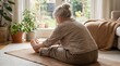 © Armando Loho - Senior woman doing seated forward bend yoga exercise on mat at home