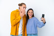 © luismolinero - Young caucasian couple isolated on white background making a selfie with the mobile