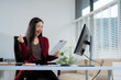 © NINENII - Overjoyed, Asian female businessman celebrates a financial bonus.