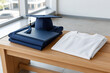 © heerim studio - Graduation Day Essentials: Cap, Gown, Diploma, and Blank Shirt on Table