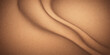 © Sayid - A brown leather and silk fabric texture background with pink satin drapery patterns flowing over the beauty of a woman's soft skin and stomach