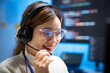 © DG PhotoStock - Asian woman wearing headset working as customer support agent