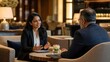 © ArtFocus Studio - Professional Indian businesswoman in a black blazer gesturing while discussing strategy with a male colleague during a corporate meeting in a luxury hotel lounge or upscale lobby.