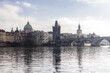© Travel 'n' Lifestyle - View of Charles Bridge and the Old Town Bridge Tower across the Vltava River with historic architecture and a soft cloudy sky Prague, Prague, Czechia.