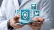 © Tiravad - Healthcare shield icon on mobile phone held by professional, medical insurance concept, glowing interface connecting family and policy symbols