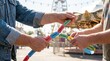 © Stitch - Two people holding and pulling apart a long chain of colorful carnival prize tickets