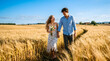 © Donnangelo - A young couple walks hand in hand through a golden wheat field on a sunny day