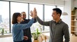 © Heri - Diverse group of professionals celebrating success with a high five in a modern office setting, symbolizing teamwork and achievement