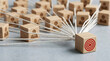 © Jagaveeran - Multiple strings pull from different directions to converge on a single red target block. The concept highlights collective effort and focus on a common goal.