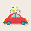 © citra - Red Car Carrying a Yellow Bicycle on its Roof
