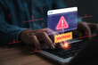 © Dilok - Cybersecurity warning and data protection concept with alert notification on laptop screen, representing cyber attack, online threat, malware detection, system security and network risk management