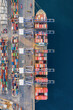 © moofushi - Overhead aerial view of a super container ship being unloaded by crynes in a commercial cargo terminal