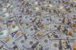 © Ruslan - Background of many scattered one hundred US dollar bills