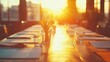 © Adawize - Beautifully Set Outdoor Dining Table Bathed in Golden Hour Sunlight with Glasses and Greenery