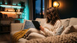 © mr_marcom - Young woman in soft cotton sweater curled on sofa using tablet in ambient evening living room