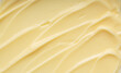 © m________k____ - Abstract background of creamy yellow texture with smooth ripples and swirls, thick custard or cosmetic cream close-up