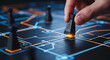 © Brokkk - A hand strategically moves a game piece on an illuminated digital network board, symbolizing business strategy and technological planning.