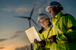 © ultramansk - Engineers analyzing smart grid data via laptop at onshore wind farm. Integrating AI technology to drive the global clean energy transition.