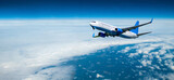Commercial airplane flying over the clouds, air travel background with white plane in the flight among high clouds in the atmosphere