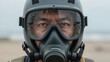 © Lubov - Close-up portrait of an Asian man wearing a tactical gas mask and safety helmet. This professional protective gear is essential for chemical defense or survival in a toxic environment