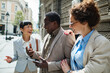 © Marko Geber - Diverse business colleagues networking on city street