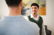 © Studio Marmellata - Two men are in conversation, one facing the camera with a smile, the other with his back to the viewer.