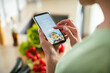 © Davor - Woman using smartphone recipe app in kitchen