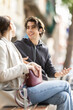 © JackF - Guy and girl on date at walking street area. Young people in love are chatting, smiling sweetly, making eyes, and relaxing. Lovers walking along European street, spring and love atmosphere.