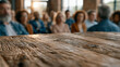 © pattozher - Shared Wisdom: A weathered wooden table stands as a symbol of unity as an audience listens attentively. Captured during a town hall meeting or conference.