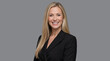 © Vyatcheslav - Portrait of a smiling blonde businesswoman in a black blazer. Confident female corporate executive headshot. Isolated on grey background