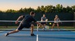 © Oleg - Active men and woman playing pickleball on an outdoor court at sunset. Recreational sports game with paddles, net and fast rally during a fitness and social competition session.