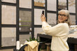 © Ivan Traimak - Woman making home improvement choices and researching flooring options at a showroom