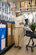 © Ivan Traimak - Senior woman shopping for bathroom fixtures in a hardware store
