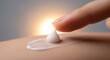 © AjayGhosh - Close-up of Finger Applying Cream with Sun Flare and Skin Texture lotion skincare
