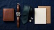 © Nawab - Elegant mens fashion accessories flat lay, brown leather watch and wallet on blue linen, formal silk necktie with cufflinks and blank invitation card