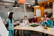 © deagreez - Young team collaborating in a modern office meeting with presentation and teamwork discussion