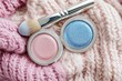 © rina - Makeup Still Life Cozy Vibes: Pastel Eyeshadows with Brush on Knitted Textile Beauty Enhancements Cosmetology Fashion Trends