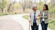 © Ievgeniia - Elderly African American woman walking with young female companion on a winding path in a park